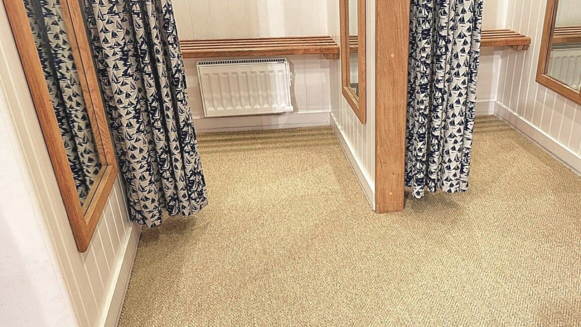 carpet installed in a fitting room in a retail clothing store