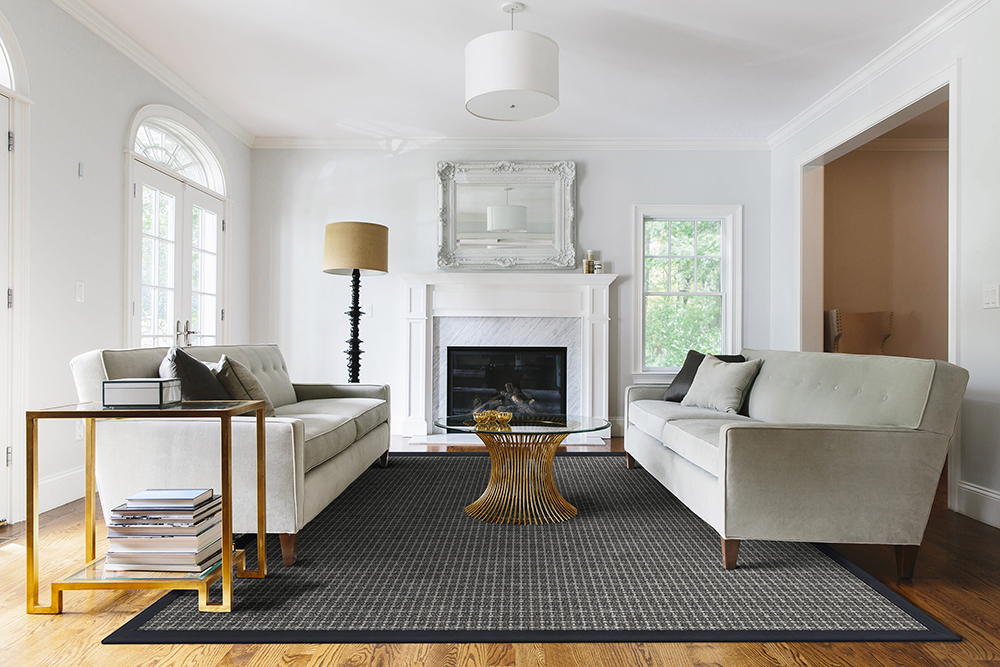 a dark wool-sisal blend area rug in living room