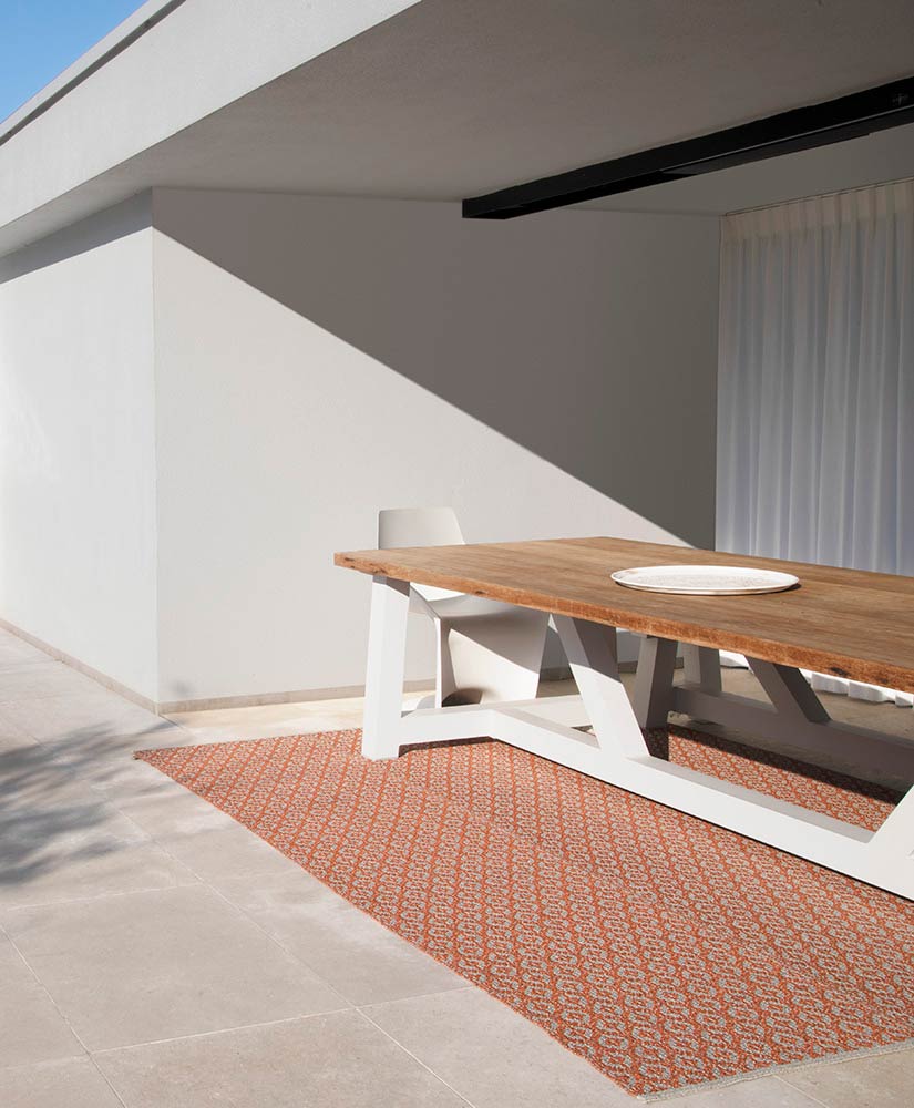 woven vinyl outdoor rug under dining table