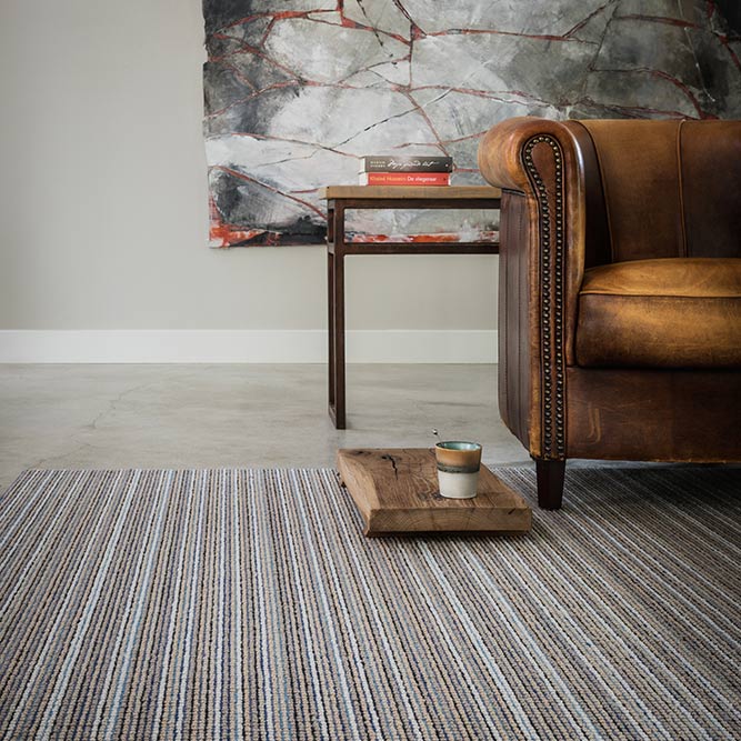 leather couch with striped colorful rug