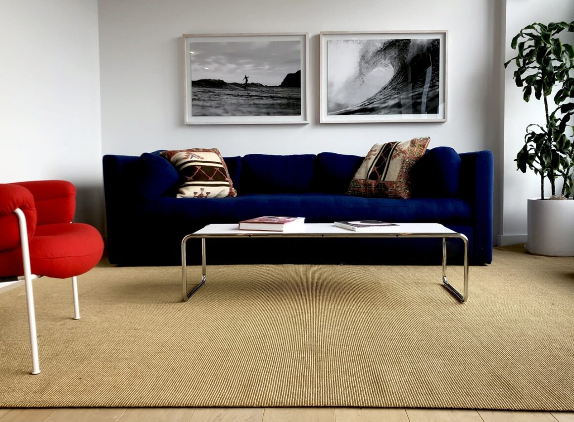 blue couch on a bouclé style tan sisal rug